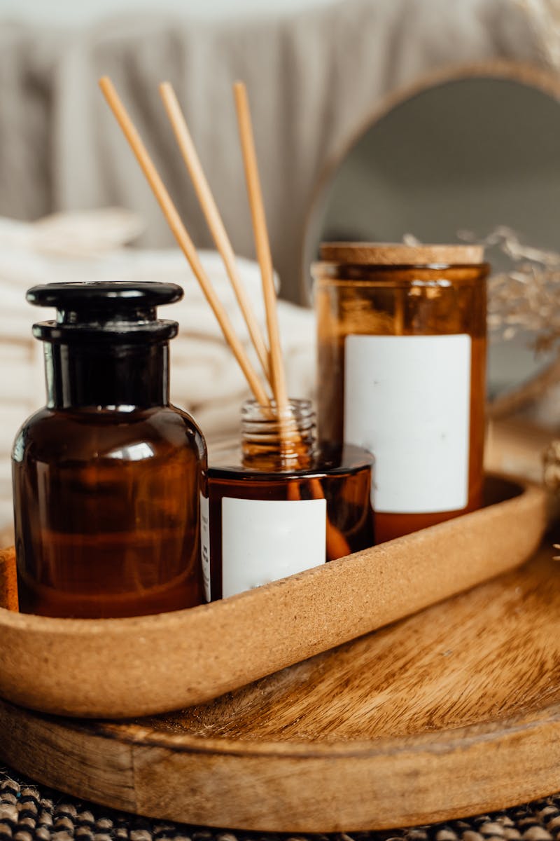 A tranquil spa setup featuring aromatherapy oils, candles, and dried flowers for relaxation.
